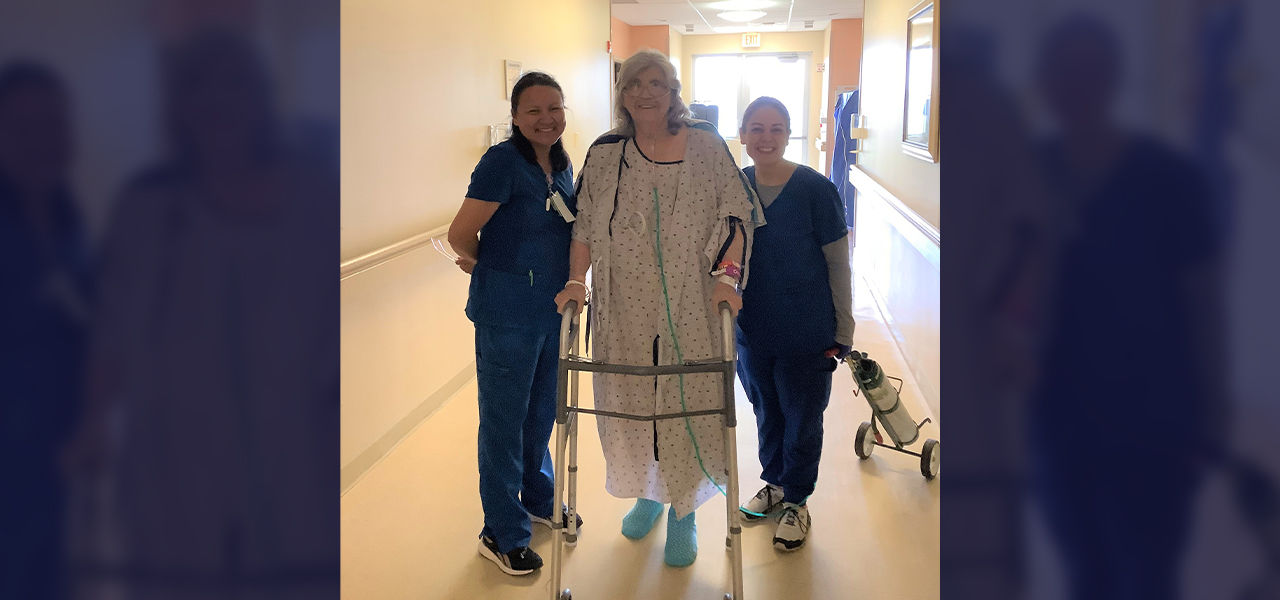 Cornerstone Specialty Hospital Muskogee patient Frankie stands with her caregivers