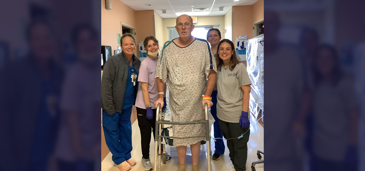 Cornerstone Specialty Hospital Muskogee patient James stands with his care team