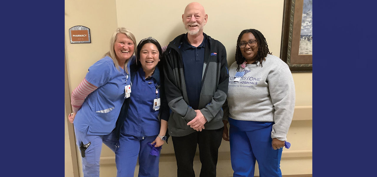 Cornerstone Specialty Hospital Broken Arrow patient Robert stands with his care team