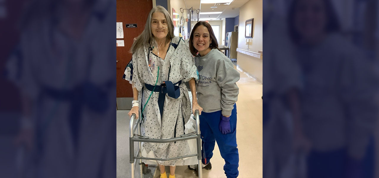 Cornerstone Specialty Hospital Muskogee patient Thresia stands with her caregiver