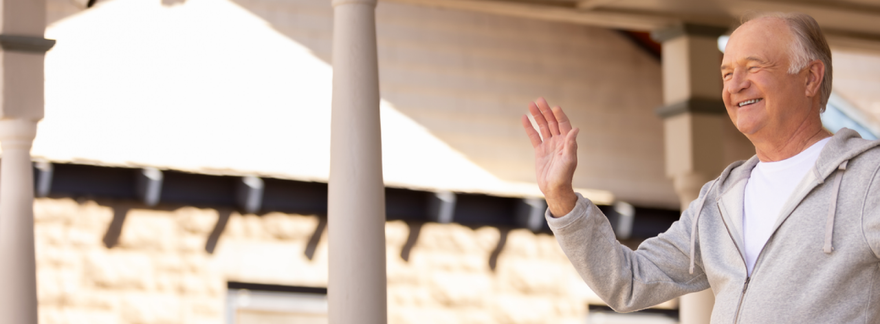 Gentleman waving on front porch